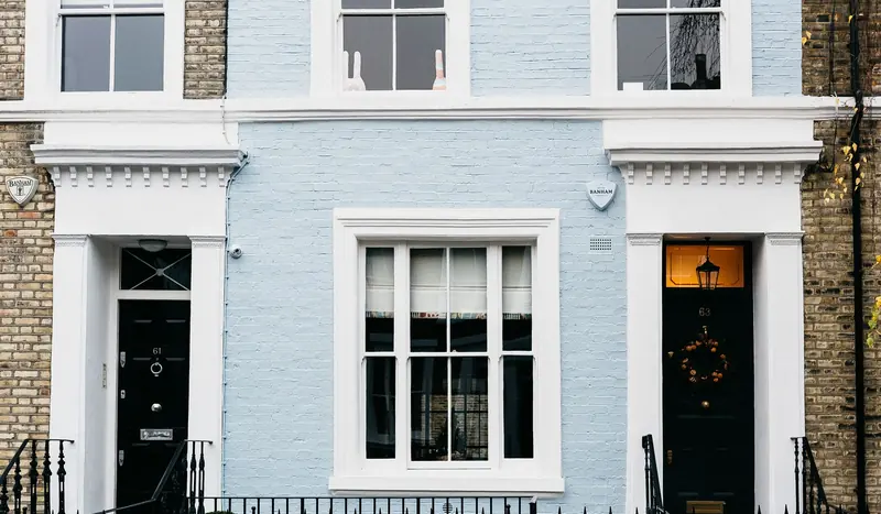 A row of stucco-fronted Victorian houses on a quiet Highbury street.
